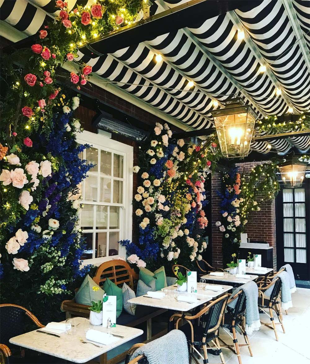 Black and white striped ceiling design with flowers at restaurant