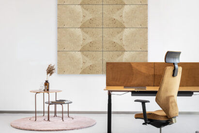 plant based acoustic tiles on wall with desk and stools on small rug