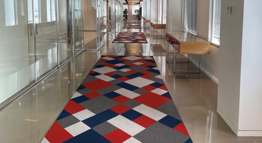 red white blue and grey wool felt rug in hallway of office building