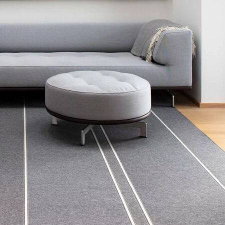 grey acoustic rug with off white linear pattern detail under sofa and chairs