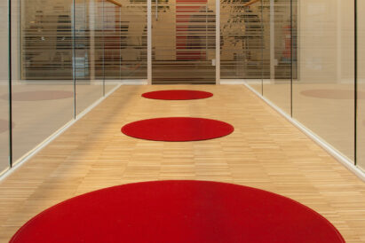 red circular Fraster Felt rugs in hallway