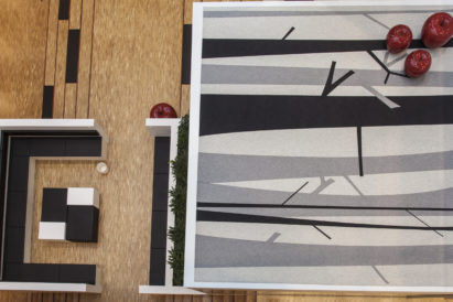 retail store with black and white tree themed acoustic rug from above