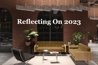 lighted acoustic baffles in a brick room with white text