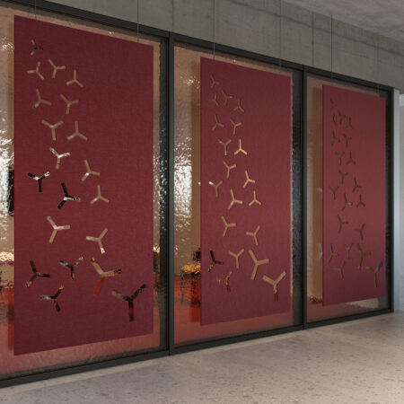 three textured red acoustic screens on glass partitions in an office