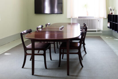 small office with dark green rug