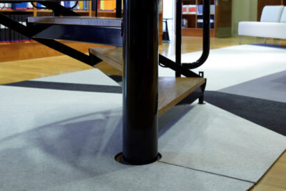 multi-colored wool felt rug wrapped around a staircase