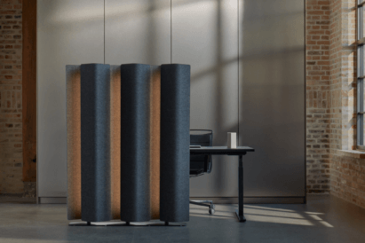 lighted acoustic floor screen in dark blue fabric covering in brick room